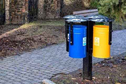 A beautiful set of bins for sorting garbage in the park. Stock Photos