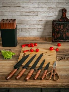 Beautiful set of knives on the background of the kitchen. Stock Photos