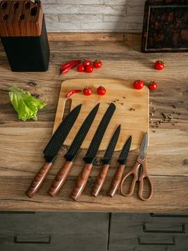 Beautiful set of knives on the background of the kitchen. Stock Photos