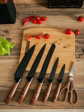 Beautiful set of knives on the background of the kitchen. Stock Photos