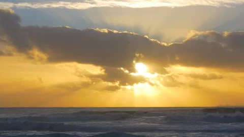 Beautiful setting sun between clouds over the ocean at sunset in Portugal Stock Footage 95033005