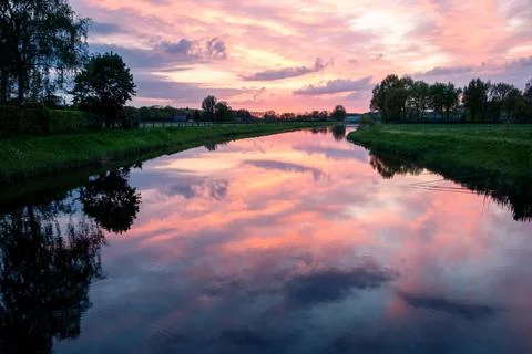 Beautiful setting sun with colored clouds Stock Photos