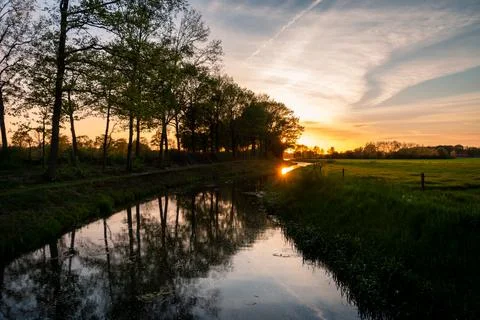Beautiful setting sun with colored clouds Stock Photos