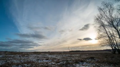Beautiful setting sun over frozen field 스톡 사진