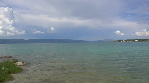 Beautiful Sevan lake in Armenia on Mountains and Clouds background. Video stock 146136622