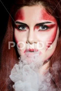 Beautiful sexy devil girl with professional make-up. Fashion Art design Stock Photos