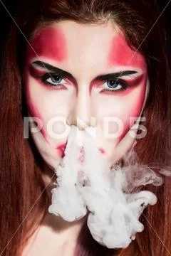 Beautiful sexy devil girl with professional make-up. Fashion Art design Stock Photos