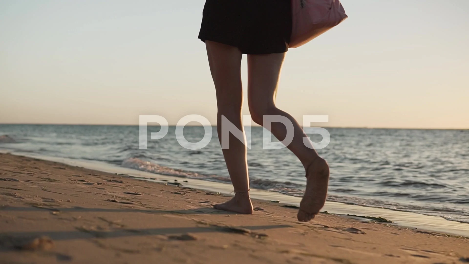 Beautiful sexy hippie girl with earrings and tattoo walking calm on the  beach,