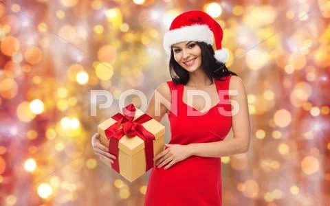 Beautiful sexy woman in santa hat with gift box Stock Photos
