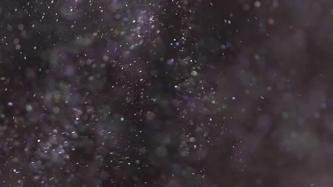 Beautiful shimmer flying on the black background, abstract slow motion Stock Footage 75972789