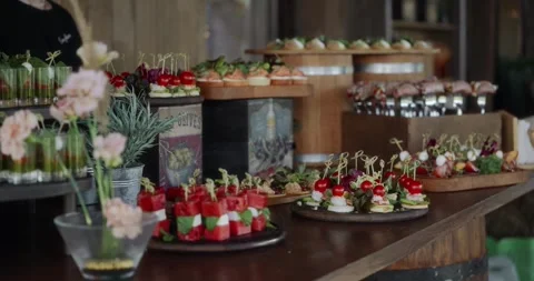 Beautiful shot of a buffet table decorated with flowers on an outdoor veranda Stock Footage 306333733