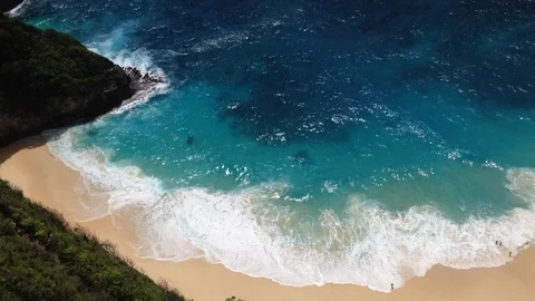 Beautiful Shot Of Deep Blue Waves Crashing Against Rock Cliff, Bali, Indonesia Stock Footage 104729166