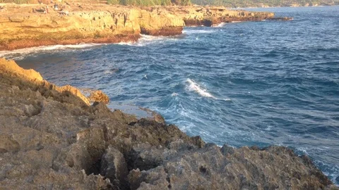 Beautiful Shot Of Deep Blue Waves Crashing Against Rock Cliff, Bali, Indonesia Stock Footage 104729218