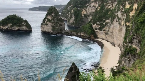 Beautiful Shot Of Deep Blue Waves Crashing Against Rock Cliff, Bali, Indonesia Stock Footage 115913925