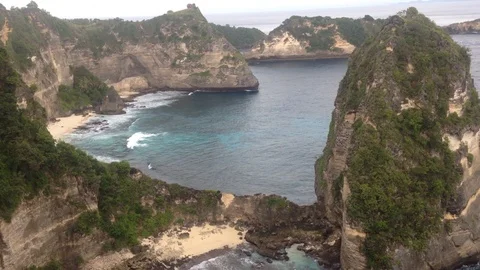 Beautiful Shot Of Deep Blue Waves Crashing Against Rock Cliff, Bali, Indonesia Stock Footage 115915133