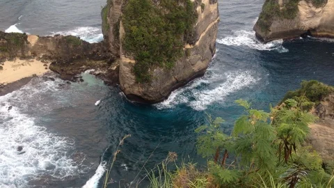 Beautiful Shot Of Deep Blue Waves Crashing Against Rock Cliff, Bali, Indonesia Stock Footage 115915188