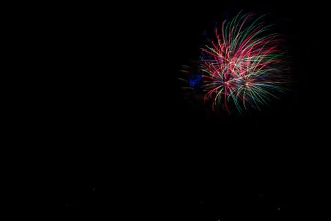 Beautiful shot of exploding colorful fireworks on a black night sky backgroun Stock Photos