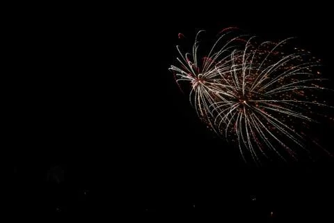 Beautiful shot of exploding colorful fireworks on a black night sky backgroun Stockfoto's