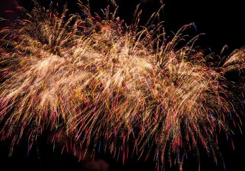 Beautiful shot of exploding colorful fireworks in a dark night sky Stock Photos