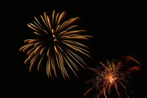 Beautiful shot of exploding colorful fireworks in a black night sky Stock Photos