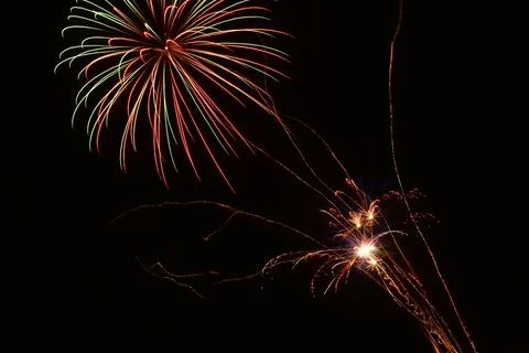 Beautiful shot of exploding colorful fireworks in a black night sky Stock Photos