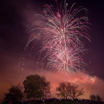 Beautiful shot of exploding colorful fireworks in a night sky over Heaton Park 库存照片