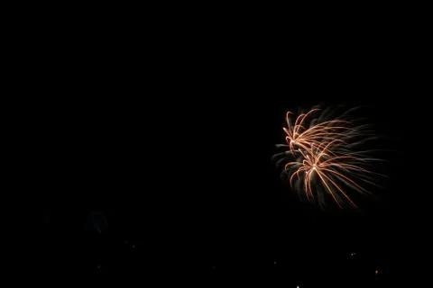 Beautiful shot of exploding orange fireworks on a black night sky background Foto stock