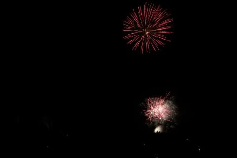 Beautiful shot of exploding red fireworks on a black night sky background Stock Photos