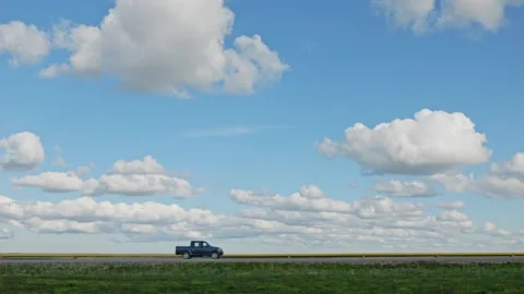 A beautiful shot of a passing SUV from left to right against the backdrop of a b Stock Footage 252216480
