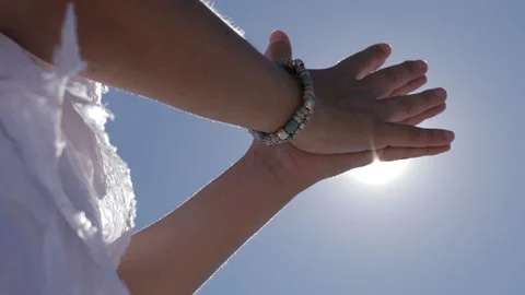 Beautiful shot of praying hands in front of the sun light Stock Footage 142160254