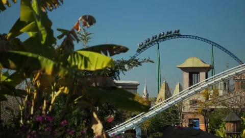 A beautiful shot of a roller coaster in an amusement park in the distance Stock Footage 229376589