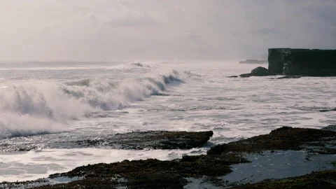 Beautiful Shot Of Rough Waves Hitting The Rocks In Tannah Lot, Bali Island Stock Footage 142206133