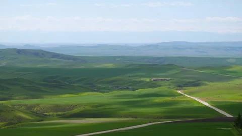 Beautiful shot of shadows of clouds run above green valley hill. Calmness nature Video stock 261205541