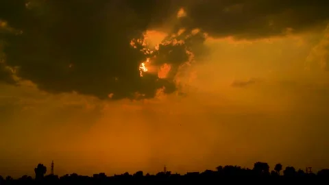 Beautiful shot of sunset behind clouds with silver lining and rays in rural  Stock Footage 210852101