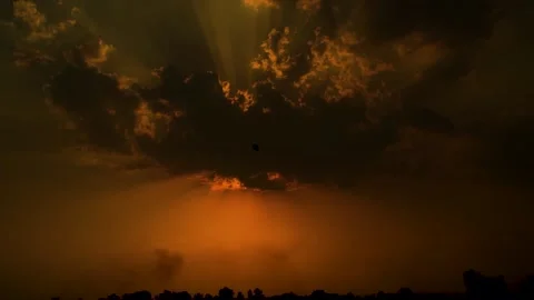 Beautiful shot of sunset behind clouds with silver lining and rays in rural  Stock Footage 210852107