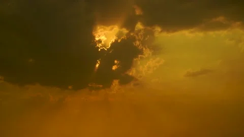 Beautiful shot of sunset behind clouds with silver lining and rays in rural  Stock Footage 210852393