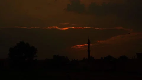 Beautiful shot of sunset behind clouds with silver lining and rays in rural  Stock Footage 210852461