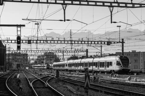 Beautiful shot of a train intersection in black and white Photos