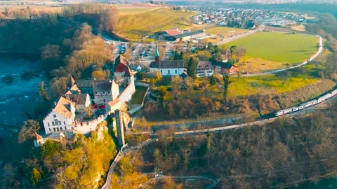 A beautiful shot of a train passing in front of the Rhine Falls and Castle Stock Footage 237091873