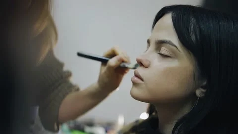 Beautiful shots of the process of applying makeup on the face of a young girl Stock Footage 171006731