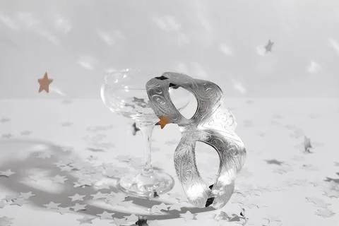 Beautiful silver carnival mask, empty glass and confetti on white background, Stock Photos