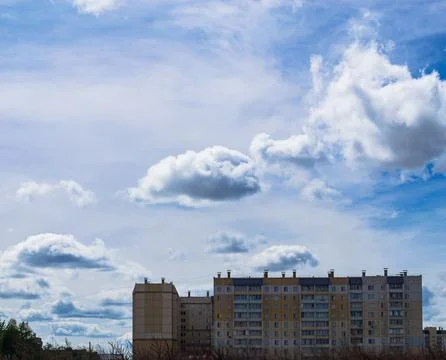 Beautiful sky and clouds over residential buildings Stock Photos