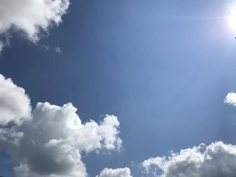Beautiful sky background with clouds in blue sky. Sunlight and Clouds Stock Photos