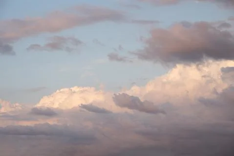 Beautiful sky background. Light blue sky with dramatic orang, pink, and gray Stock Photos