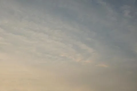 Beautiful sky background. Light blue sky with dramatic white and gray clouds. Stock Photos