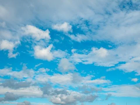 Beautiful sky on a clear sunny day. White clouds against the blue sky. Stock Photos