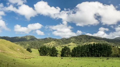 Beautiful sky clouds over green mountains and farm land in nature Time lapse Video stock 106877484