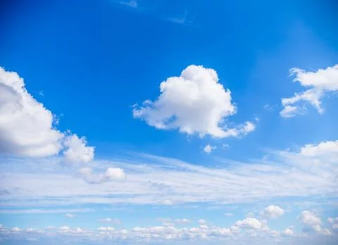Beautiful sky featuring an array of white, fluffy clouds amidst a bright blue ba Foto stock