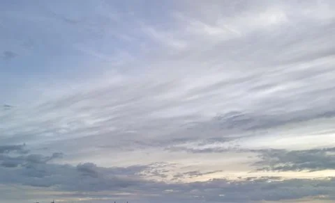 A beautiful sky showcasing soft clouds and a gradient of colors during twilight. Stock Photos