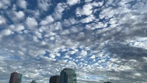 Beautiful sky tapestry of clouds clearing up in urban environment Vídeo Stock 147178584